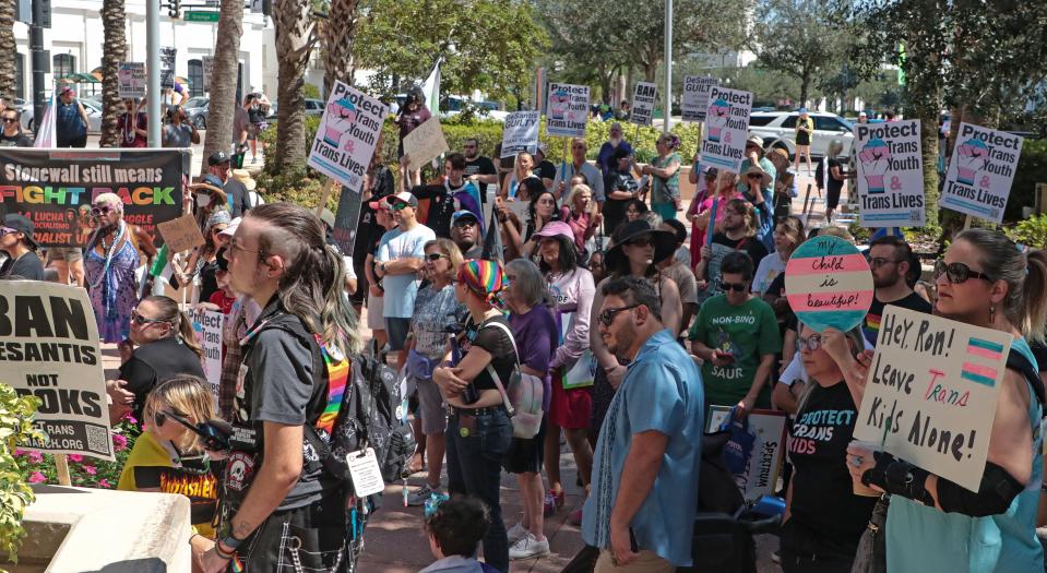 Protesters rally together before the start of the National March to Protect Trans Youth Saturday, Oct. 7, 2023, in Orlando.