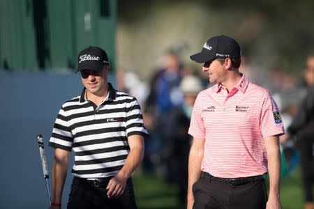 Jan 31, 2019; Scottsdale, AZ, USA; Justin Thomas (left) and Webb Simpson (right) walk to the green of the 15th hole during the first round of the Waste Management Phoenix Open golf tournament at TPC Scottsdale. Mandatory Credit: Allan Henry-USA TODAY Sports