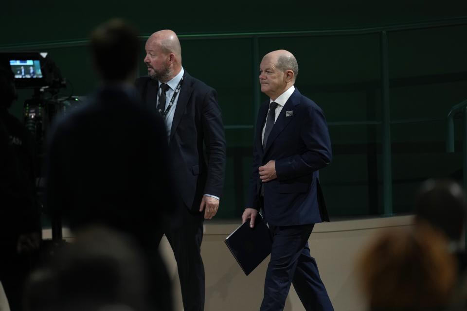 Germany Chancellor Olaf Scholz leaves after speaking during a plenary session at the COP28 U.N. Climate Summit, Saturday, Dec. 2, 2023, in Dubai, United Arab Emirates. (AP Photo/Rafiq Maqbool)