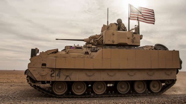 PHOTO: In this Dec. 8, 2021, file photo, American soldiers drive a Bradley fighting vehicle during a joint exercise with Syrian Democratic Forces at the countryside of Deir Ezzor in northeastern Syria. (Baderkhan Ahmad/AP, FILE)