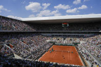 Karolina Muchova of the Czech Republic, near side, serves against Aryna Sabalenka of Belarus during their semifinal match of the French Open tennis tournament at the Roland Garros stadium in Paris, Thursday, June 8, 2023. (AP Photo/Thibault Camus)