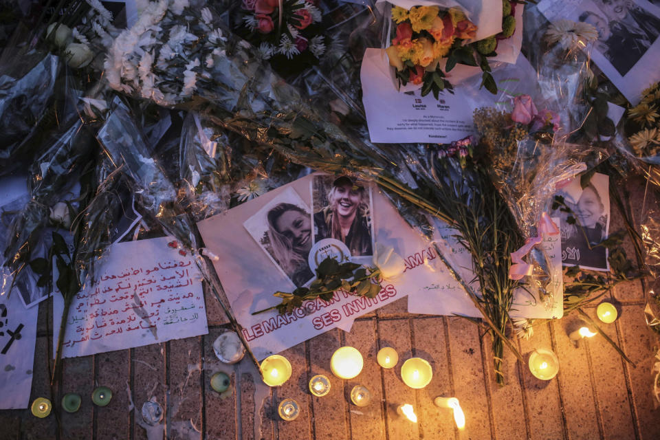 Flowers, candles and messages are laid during a vigil outside the Norwegian embassy in Rabat. Image: AP