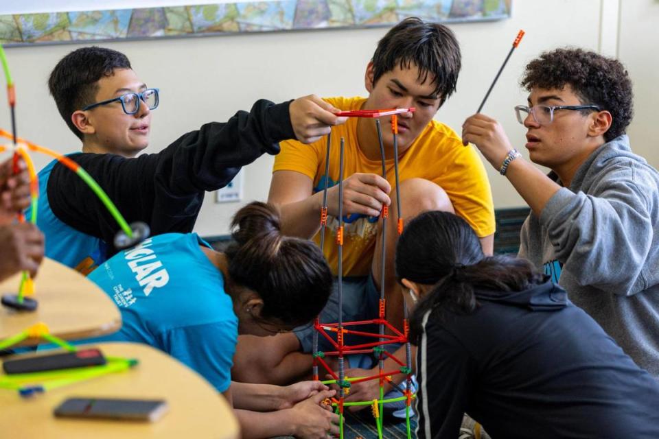 Volunteer teachers interact with students during a Breakthrough Miami, after-school program for middle students held at Ransom Everglades Middle School in Miami, Florida, on Saturday October 14, 2023. Students work with Breakthrough teachers - who often are high school volunteers - on project-based learning activities, such as an environmental science project.