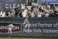 Detroit Tigers center fielder Parker Meadows (22) leaps for a home run hit by New York Yankees' DJ LeMahieu during the first inning of a baseball game Tuesday, Sept. 5, 2023, in New York. (AP Photo/Adam Hunger)