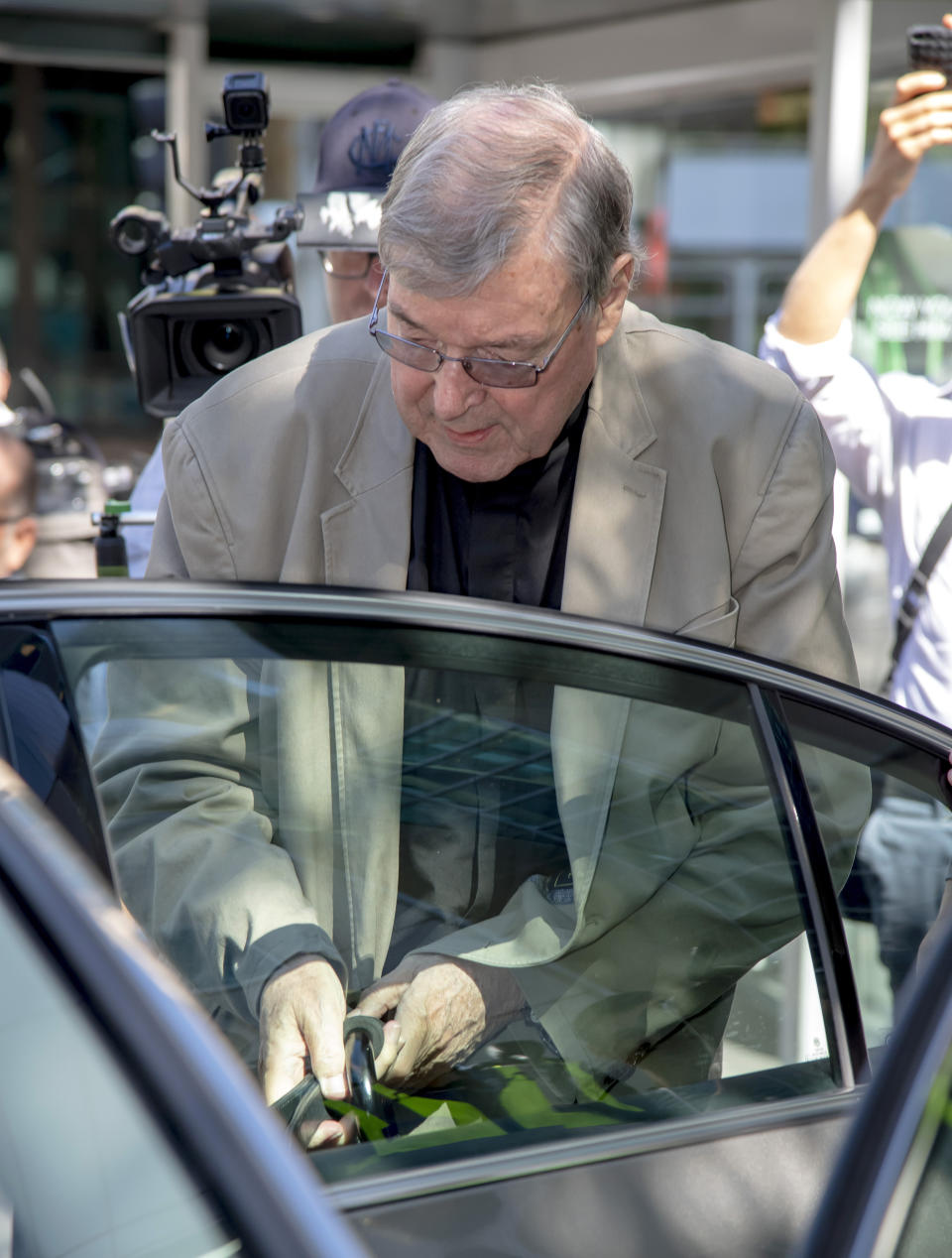 In this Friday, Feb. 22, 2019, photo, Cardinal George Pell leaves the County Court in Melbourne, Australia. The most senior Catholic cleric ever charged with child sex abuse has been convicted on Tuesday, Feb. 26, 2019 of molesting two choirboys moments after celebrating Mass, dealing a new blow to the Catholic hierarchy's credibility after a year of global revelations of abuse and cover-up. (AP Photo/Andy Brownbill)