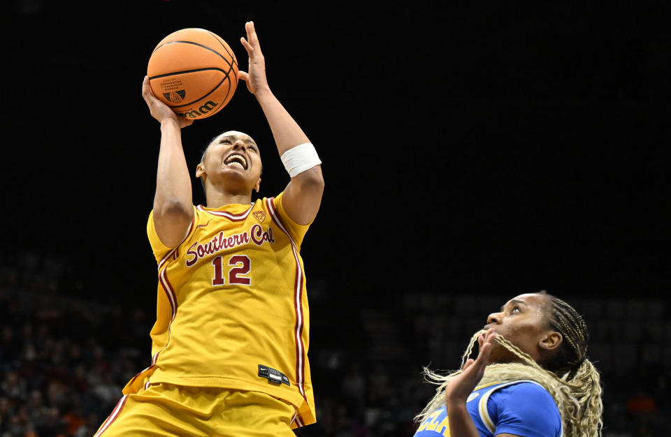 Southern California guard JuJu Watkins (12) shoots against UCLA guard Charisma Osborne during the second half of an NCAA college basketball game in the semifinals of the Pac-12 women's tournament Friday, March 8, 2024, in Las Vegas. (AP Photo/David Becker)