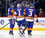 May 6, 2016; Brooklyn, NY, USA; New York Islanders goalie Thomas Greiss (1) being helped off the ice after suffering equipment problem during the second period of game four of the second round of the 2016 Stanley Cup Playoffs at Barclays Center. Mandatory Credit: Brad Penner-USA TODAY Sports