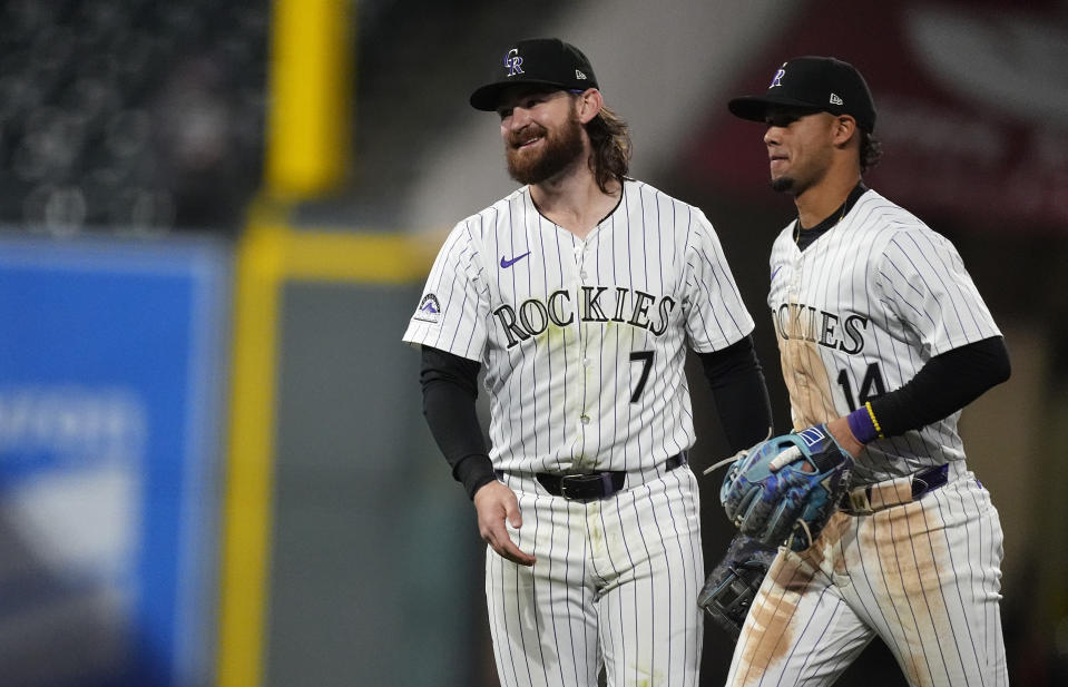 Colorado Rockies second baseman Brendan Rodgers, left, celebrates with shortstop Ezequiel Tovar after the team's baseball game against the San Diego Padres on Tuesday, April 23, 2024, in Denver. (AP Photo/David Zalubowski)