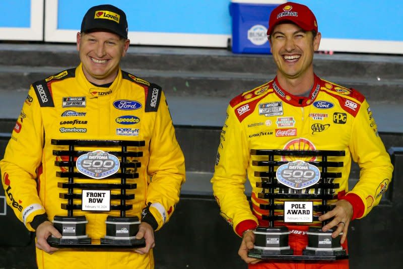 Michael McDowell (L) and Joey Logano pose after qualifying for the 66th Daytona 500 on Wednesday in Daytona Beach, Fla. Photo by Mike Gentry/UPI