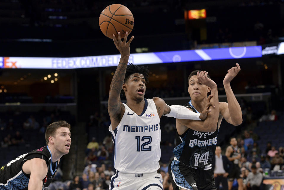 Memphis Grizzlies guard Ja Morant (12) drives ahead of New Zealand Breakers guard R.J. Hampton (14) in the first half of an exhibition NBA basketball game Tuesday, Oct. 8, 2019, in Memphis, Tenn. (AP Photo/Brandon Dill)