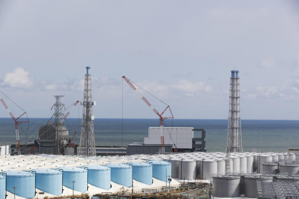The Pacific Ocean looks over nuclear reactor units of No. 3, left, and 4 at the Fukushima Daiichi nuclear power plant in Okuma town, Fukushima prefecture, northeastern Japan, Saturday, Feb. 27, 2021. (AP Photo/Hiro Komae)
