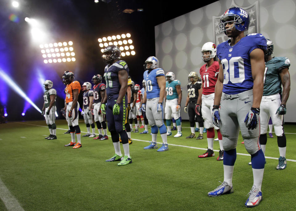 NFL uniforms are displayed during a presentation in New York, Tuesday, April 3, 2012. The league and Nike showed off the new look in grand style Tuesday with a gridiron-styled fashion show at a Brooklyn film studio. (AP Photo/Seth Wenig)