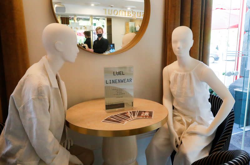Mannequins dressed in creations of local designer sit at the table in a restaurant during the coronavirus disease (COVID-19) outbreak in Vilnius