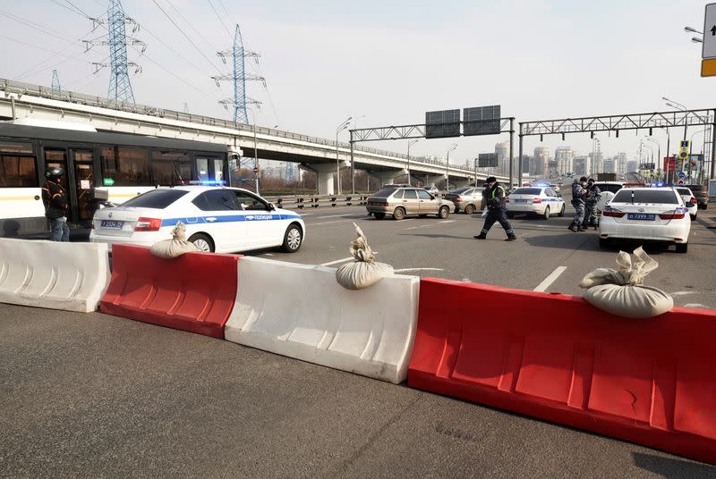 Law enforcement officers and traffic police work at a checkpoint in Moscow