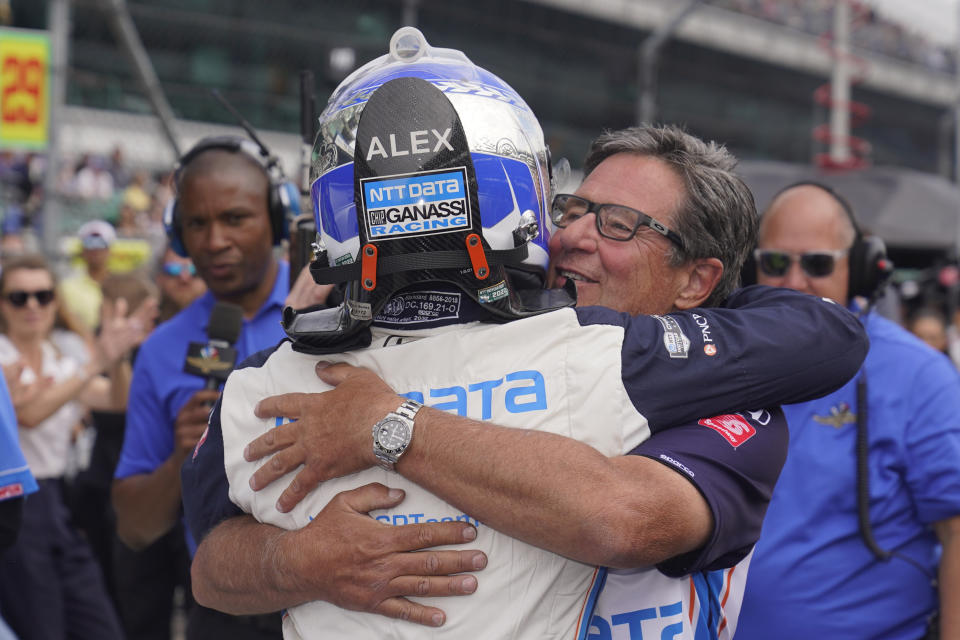 Alex Palou, of Spain, gets a hug from Barry Wasner, front right, during qualifications for the Indianapolis 500 auto race at Indianapolis Motor Speedway, Sunday, May 22, 2022, in Indianapolis. (AP Photo/Darron Cummings)