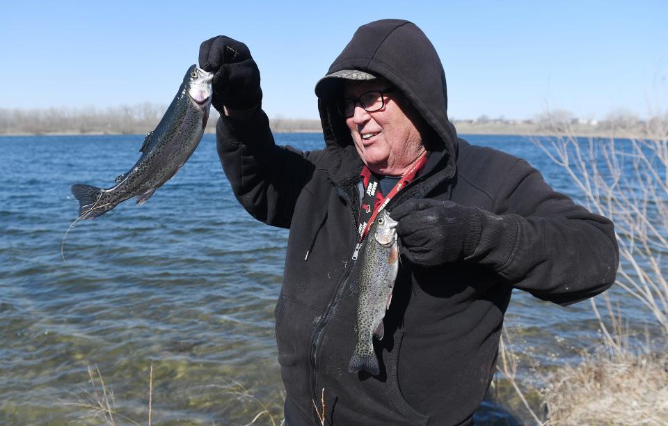 Mike Kipp shows trout he caught at the Spring Fishing Day hosted by Ames Parks and Recreation and JAX Outdoor Gear at Ada Hayden Park Saturday, April 16, 2022, in Ames.