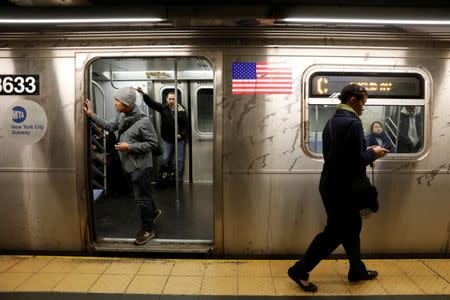 FILE PHOTO: Passengers wait inside a stopped C subway train in New York City after a power failure stopped multiple subway lines during the morning commute in New York, U.S., April 21, 2017. REUTERS/Brendan Mcdermid/File Photo