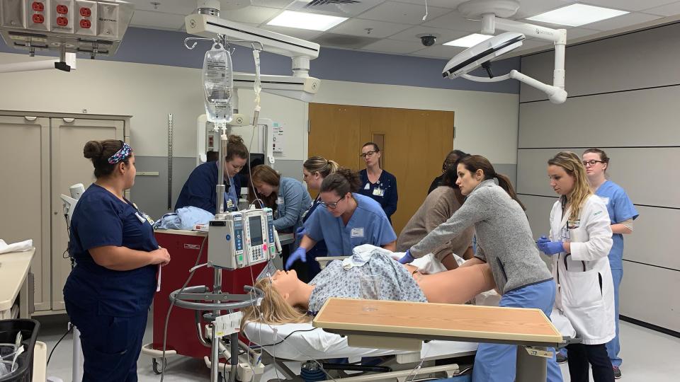 Christiana Care Health System doctors and nurses complete a training session at the Virtual Education and Simulation Training Center. A patient, in this case a manikin, is hemorrhaging hours after giving birth.