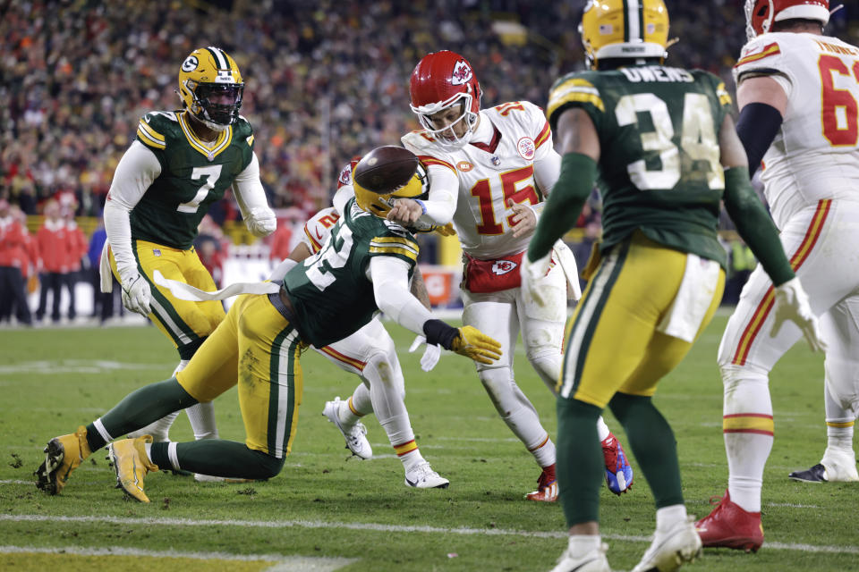 Green Bay Packers linebacker Rashan Gary (52) applies pressure to Kansas City Chiefs quarterback Patrick Mahomes (15) as he tries to pass the ball forward during the second half of an NFL football game Sunday, Dec. 3, 2023 in Green Bay, Wis. (AP Photo/Mike Roemer)