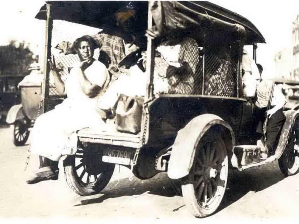 A woman rides on the back of truck during the Tulsa Race Massacre in 1921.