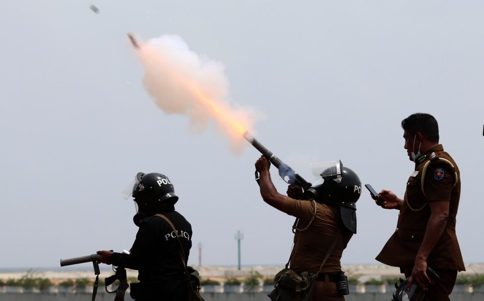 Riot police officer fires tear gas to clear pro-democracy protesters amidst clashes in Colombo - Riot police officer fires tear gas to clear pro-democracy protesters amidst clashes in Colombo