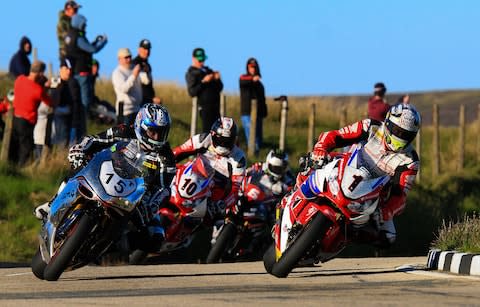 Motorbikes racing at the Isle of Man TT race - Credit: Getty