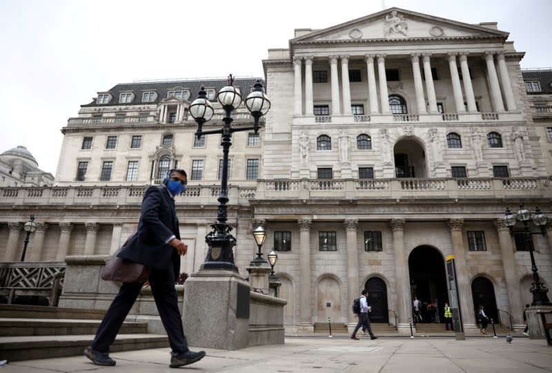 FILE PHOTO: FILE PHOTO: A person walks past the Bank of England in the City of London financial district