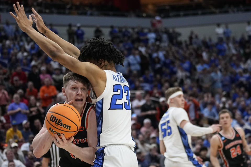 Princeton guard Matt Allocco (14) runs into Creighton guard Trey Alexander (23) in the first half of a Sweet 16 round college basketball game in the South Regional of the NCAA Tournament, Friday, March 24, 2023, in Louisville, Ky. (AP Photo/John Bazemore)