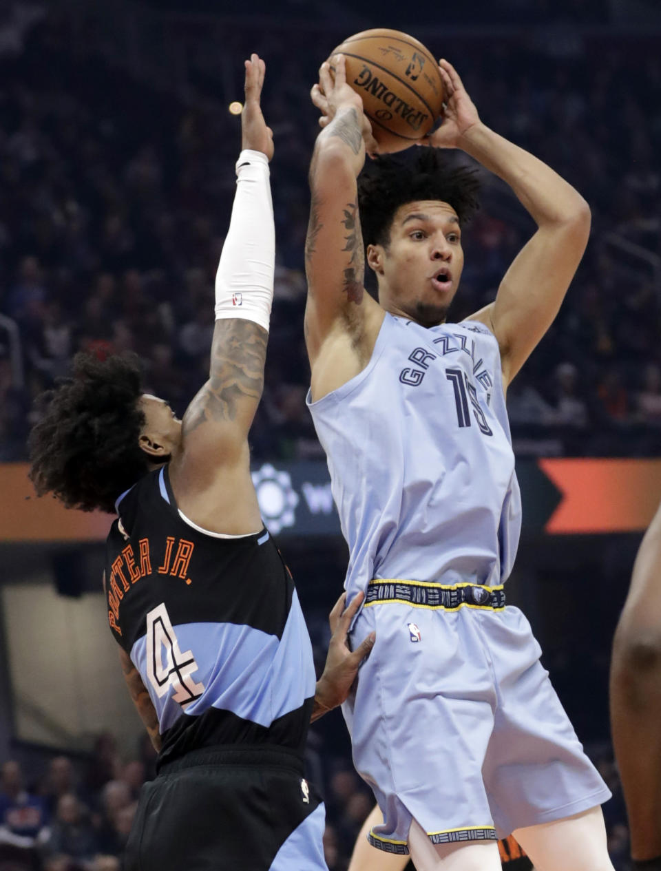 Memphis Grizzlies' Brandon Clarke (15) passes against Cleveland Cavaliers' Kevin Porter Jr. (4) in the first half of an NBA basketball game, Friday, Dec. 20, 2019, in Cleveland. (AP Photo/Tony Dejak)