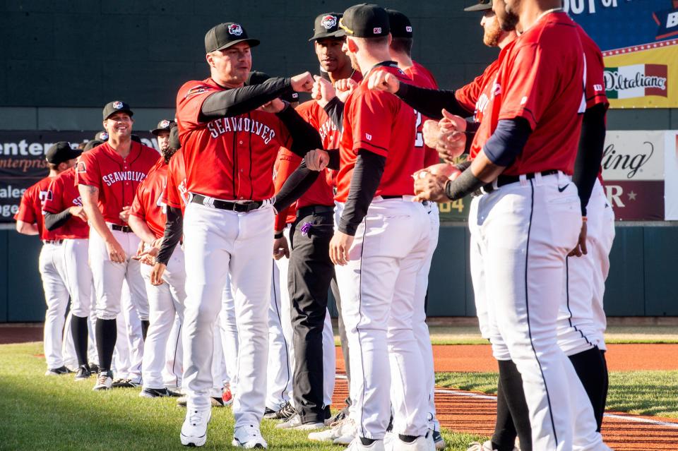 Erie SeaWolves manager Gabe Alvarez fist pumps with his team at the start of the SeaWolves versus Akron RubberDucks season-opening game held on April 8, 2022, at UPMC Park in Erie. The SeaWolves won the game 2-0.
