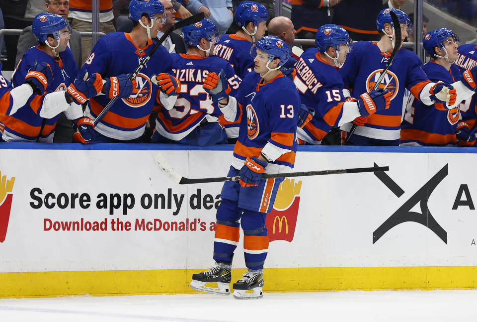 New York Islanders center Mathew Barzal (13) celebrates with teammates after scoring a goal against the Tampa Bay Lightning during the first period of an NHL hockey game, Thursday, Feb. 8, 2024, in New York. (AP Photo/Noah K. Murray)