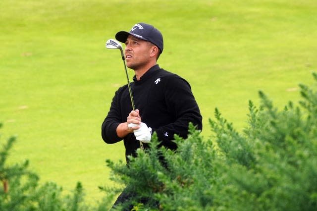 Xander Schauffele appears to kiss his club on the 11th