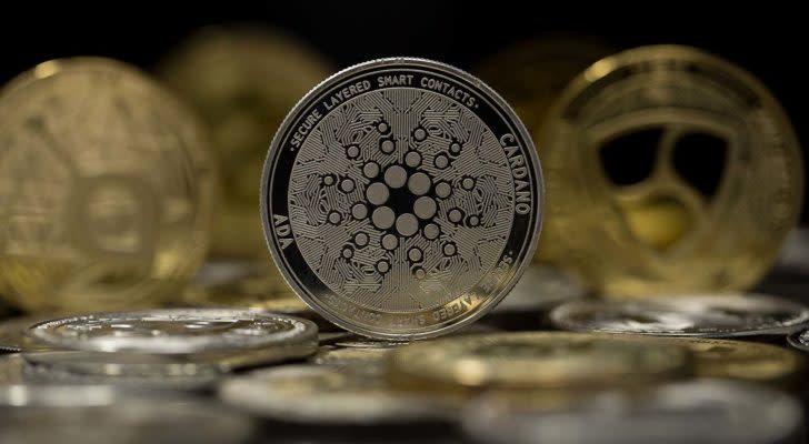 The Cardano token with other gold and silver tokens in the background.