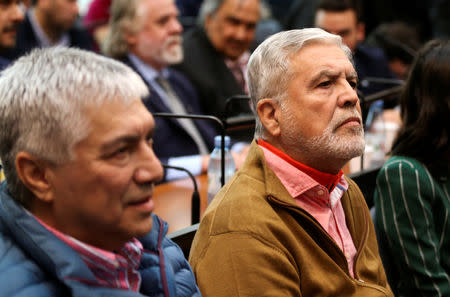 Former Planning Minister Julio De Vido (R), sits in a court room next to Argentine businessman Lazaro Baez, before the start of a corruption trial, in Buenos Aires, Argentina May 21, 2019. REUTERS/Agustin Marcarian