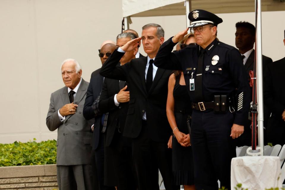 Family, friends, city officials and fellow officers salute fallen Los Angeles Police Officer Houston Tipping as they gather at Forest Lawn Hollywood Hills - Hall of Liberty Mosaic Deck for his funeral Wednesday, June 22, 2022, in Los Angeles (AP)