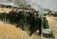 <p>A Jewish settler struggles with an Israeli security officer during clashes that erupted as authorities evacuated the West Bank settlement outpost of Amona, east of the Palestinian town of Ramallah, on Feb. 1, 2006. Oded Balilty of the Associated Press won the Pulitzer Prize for breaking news photography for this image. (Photo: Oded Balilty/AP) </p>