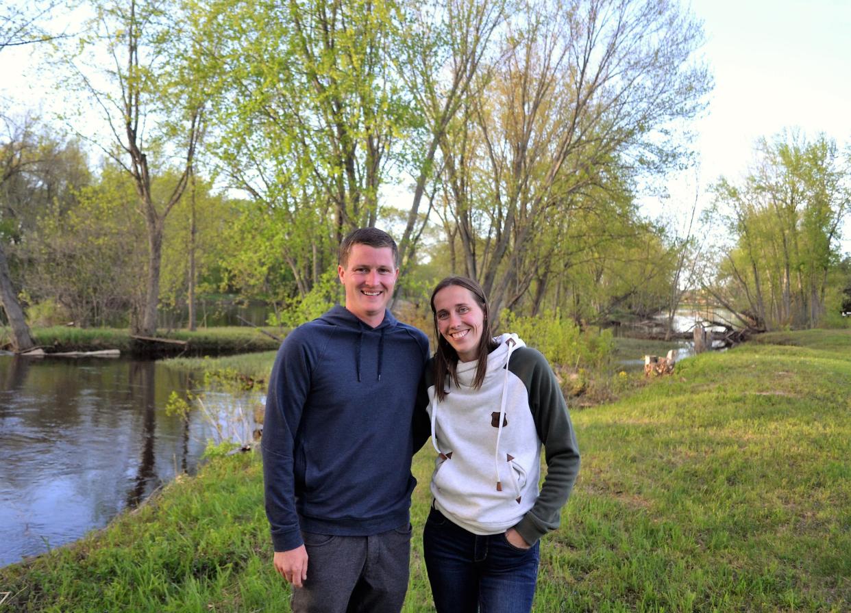 Garrett and Courtney Sowle are seen by the Oconto River on the property adjacent to Holtwood Park. They opened their beer garden on the property on Friday.