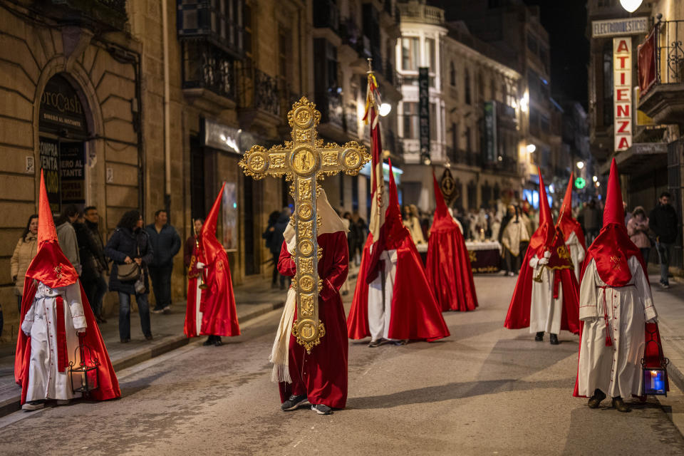 Members of "Muy Antigua Hermandad del Señor de la Humildad y María Santísima de los Dolores" Catholic brotherhood walk during a Holy Week procession in the southern city of Alcala la Real, Spain, Thursday, March 28, 2024. (AP Photo/Bernat Armangue)