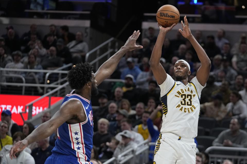 Indiana Pacers' Myles Turner (33) shoots over Philadelphia 76ers' Joel Embiid during the second half of an NBA basketball game Thursday, Jan. 25, 2024, in Indianapolis. (AP Photo/Darron Cummings)