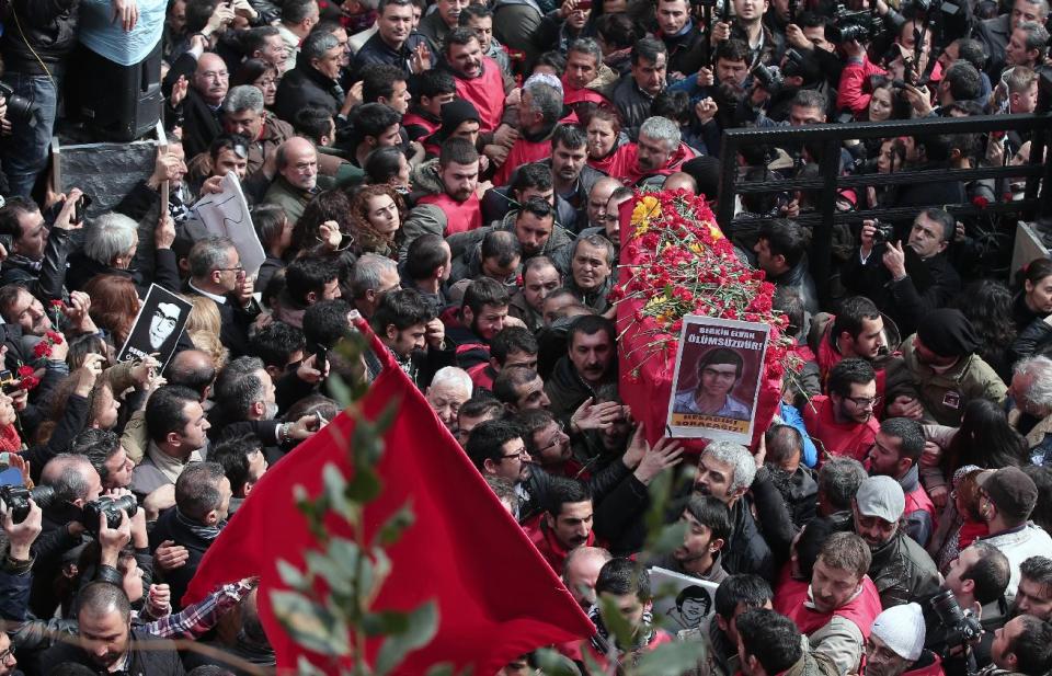 People carry the coffin of Berkin Elvan, a Turkish teenager who was in a coma since being hit on the head by a tear gas canister fired by police during anti-government protests in the summer of 2013, during his funeral in Istanbul, Turkey, Wednesday, March 12, 2014. On Wednesday, thousands converged in front of a house of worship calling for Prime Minister Recep Tayyip Erdogan to resign.(AP Photo/Emrah Gurel)