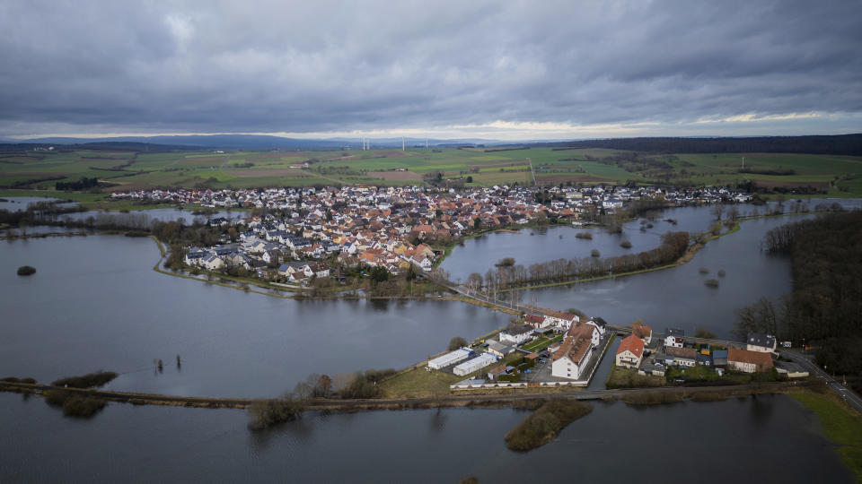 Buildings are surrounded by floodwater in the village of Eichen, Germany, Thursday, Dec. 28, 2023. Almost every year, the water stands on low-lying meadows that surround the district of Nidderau in central Germany. (Andreas Arnold/dpa via AP)