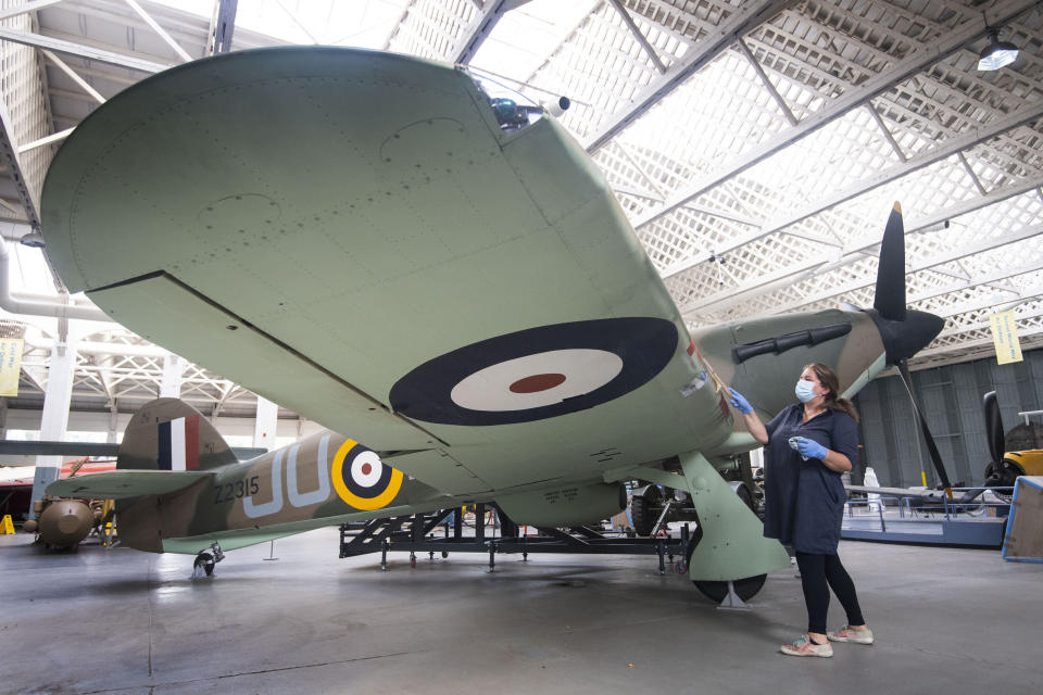 File photo dated 18/08/20 of Samantha Archetti, Collections Care Technician, cleaning a Hurricane ahead of the reopening of the Battle of Britain exhibition at IWM Duxford, which marks 80 years since the German Luftwaffe began its air attacks at the start of the Battle of Britain. Issue date: Tuesday September 15, 2020. The battle was a major air campaign fought in the skies over the UK in 1940 and was the first battle in history fought entirely in the air. Though the battle took place between July and October 1940, September 15 saw the British Royal Air Force (RAF) gain a decisive victory over the Luftwaffe in what was Nazi Germany�s largest daylight attack. A variety of tributes and commemorations will take place across the UK to mark the 80th anniversary of the Battle of Britain despite limitations caused by the coronavirus crisis. See PA story MEMORIAL Battle. Photo credit should read: Victoria Jones/PA Wire