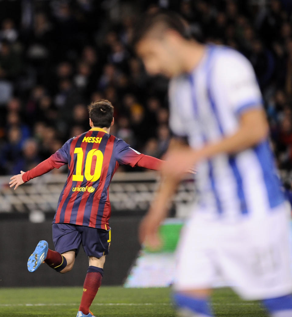 FC Barcelona's Lionel Messi of Argentina left, celebrates after scoring his goal against Real Sociedad, during their Spanish Copa del Rey semifinal second leg soccer match, at Anoeta stadium, in San Sebastian northern Spain, Wednesday, Feb. 12, 2014. (AP Photo/Alvaro Barrientos)