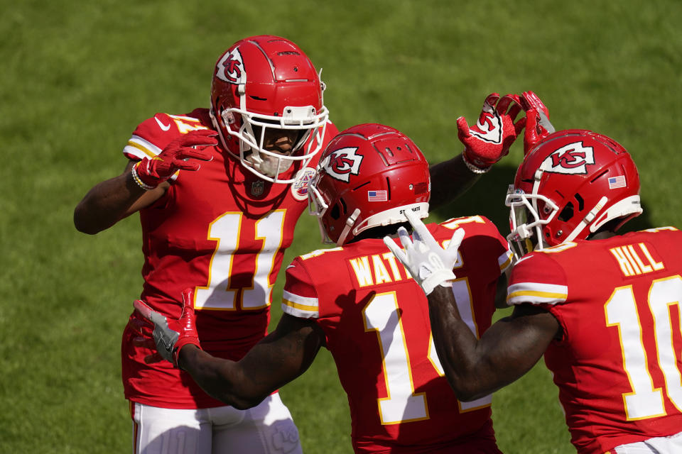 Kansas City Chiefs wide receiver Sammy Watkins, center, celebrates with teammates Demarcus Robinson, left, and Tyreek Hill, right, after catching an 8-yard touchdown pass during the first half of an NFL football game against the Las Vegas Raiders, Sunday, Oct. 11, 2020, in Kansas City. (AP Photo/Charlie Riedel)