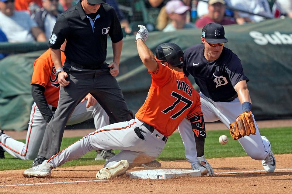 Baltimore Orioles' Terrin Vavra slides safely into third base after hitting a triple as Detroit Tigers third baseman Tyler Nevin reaches for the ball during the fourth inning of a spring training baseball game Thursday, March 2, 2023, in Lakeland, Fla.