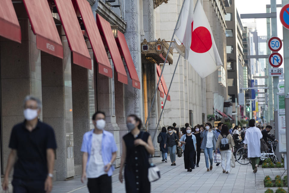 People walk past a department store in Tokyo, on Sept. 23, 2021. The Japanese economy has contracted at an annual rate of 1.2% in the July-September, 2022, quarter, as consumption declined amid rising prices. (AP Photo/Hiro Komae)