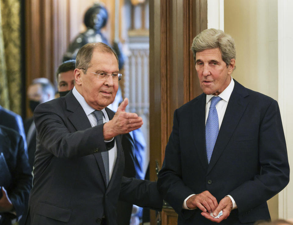 Russian Foreign Minister Sergey Lavrov, left, welcomes U.S. climate envoy John Kerry for the talks during their meeting in Moscow, Russia, Monday, July 12, 2021. (Dimitar Dilkoff/Pool Photo via AP)