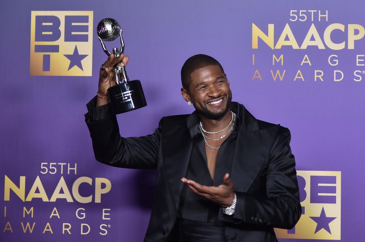 Usher poses with his entertainer of the year trophy during the 55th annual NAACP Image Awards on March 16, 2024.