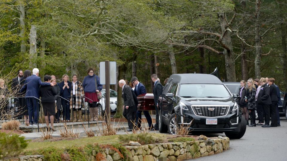 Surrounded by Meghan Moore's family, pallbearers carry her casket on Wednesday into Our Lady of Victory in Centerville. A funeral mass was held for Moore, who was shot and killed on March 16 in Miami. Moore was buried at St. Francis Xavier Cemetery in Centerville.