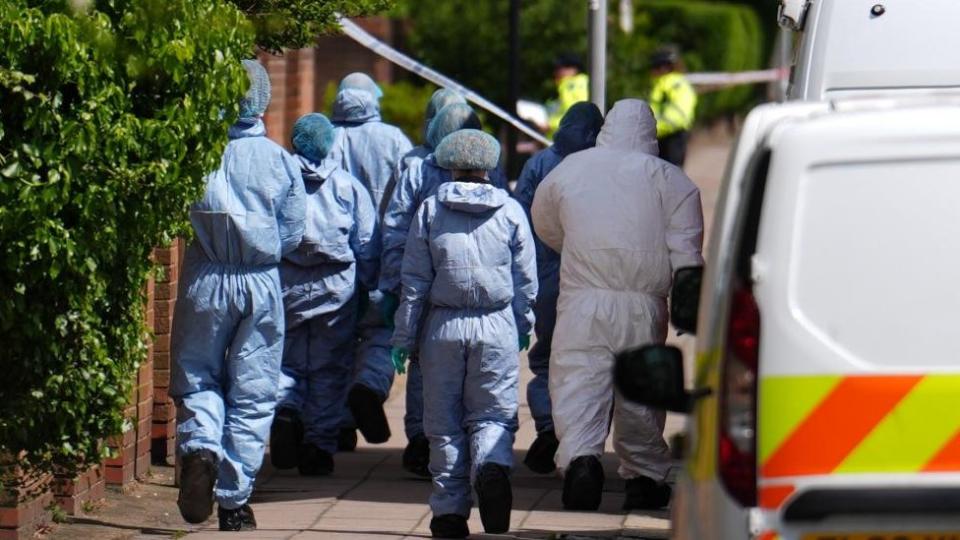 Forensic investigators on a residential road